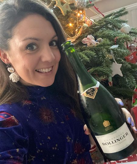 Laura Tobin poses a picture with a champagne.